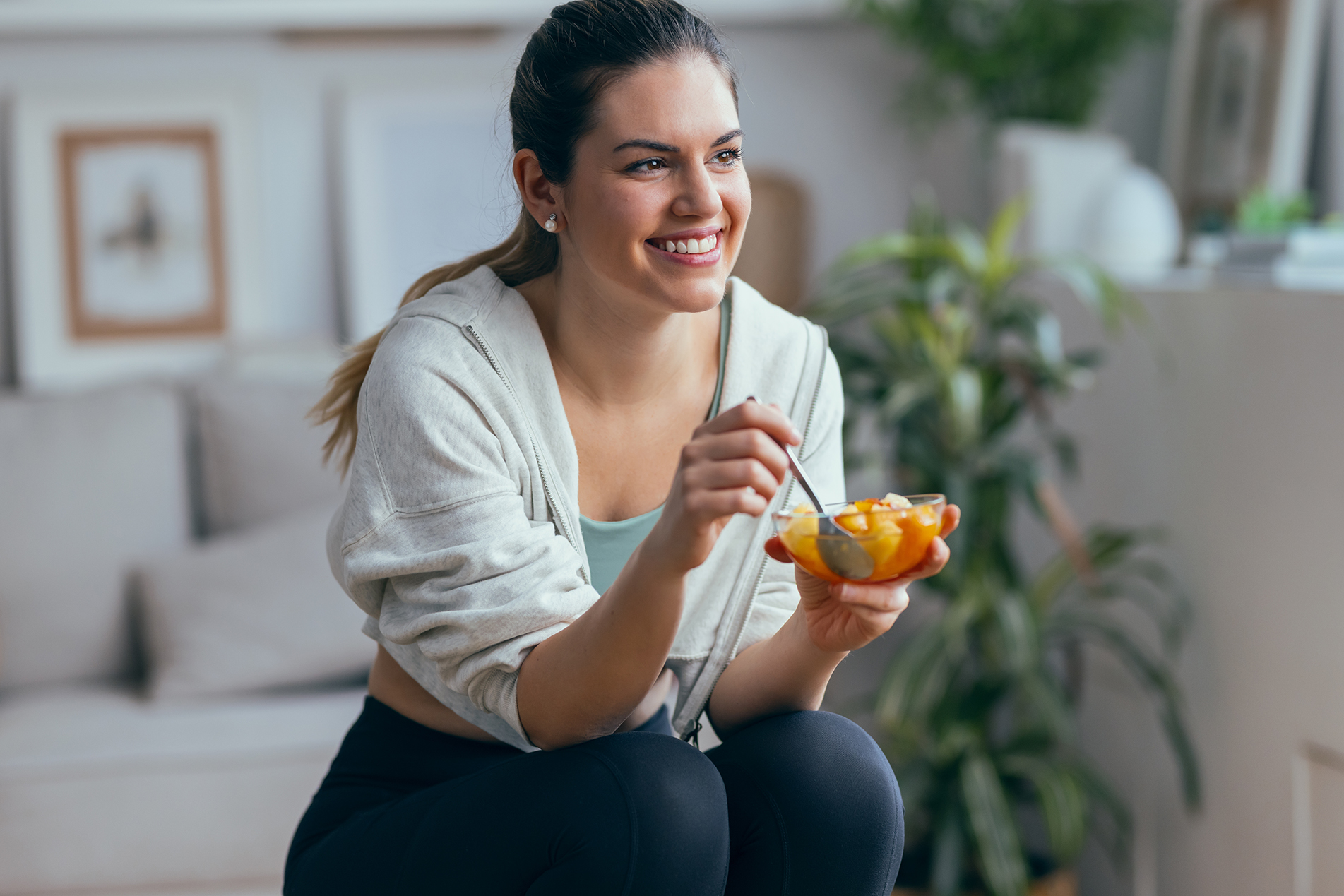 Shot,Of,Smiling,Sporty,Woman,Eating,A,Healthy,Fruit,Bowl