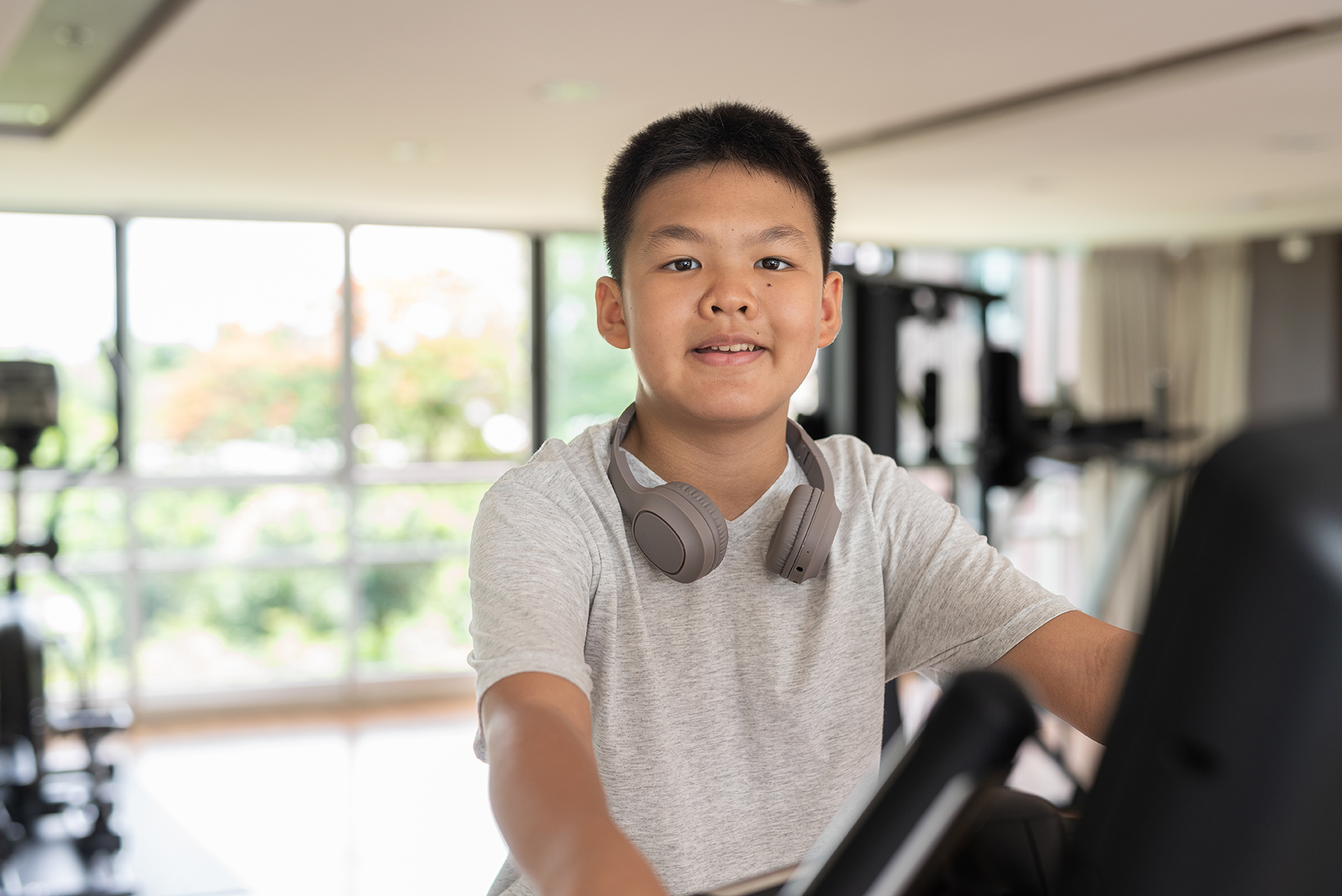 Young,Asian,Teen,Boy,Working,Out,On,Exercise,Bike